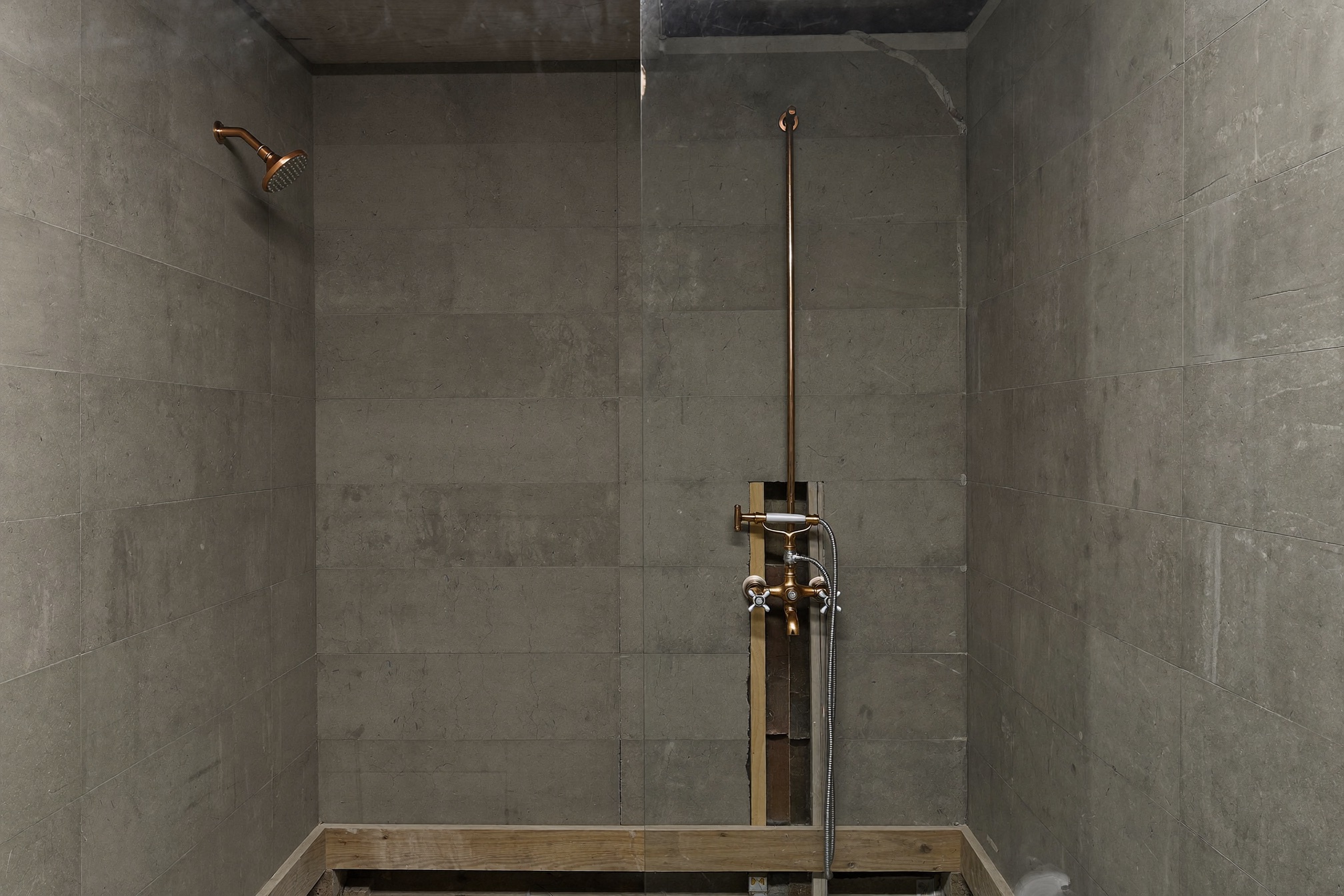 The same bath during rough-in with backer board and copper plumbing