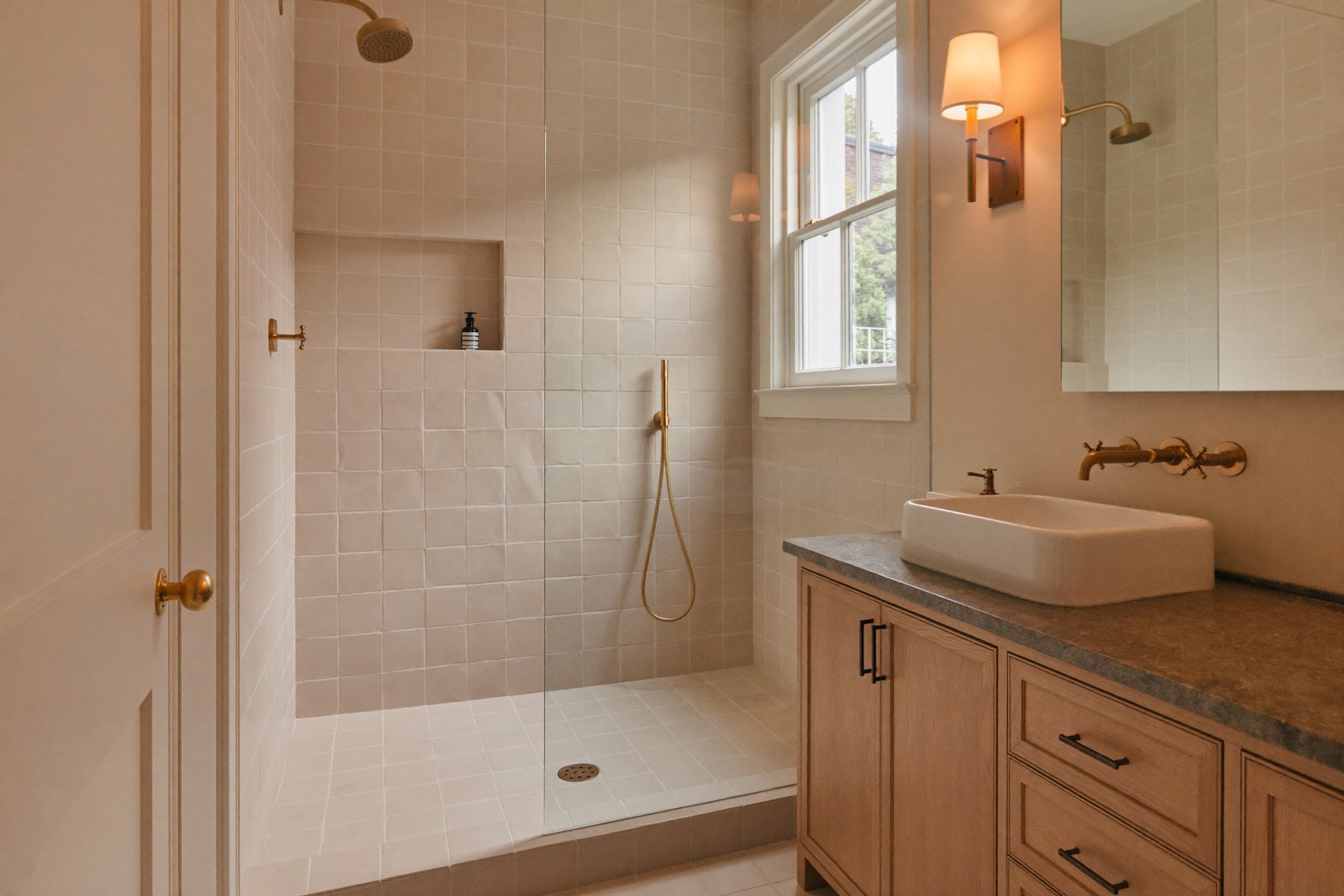 Finished primary bath with tiled walk-in shower and brass fixtures