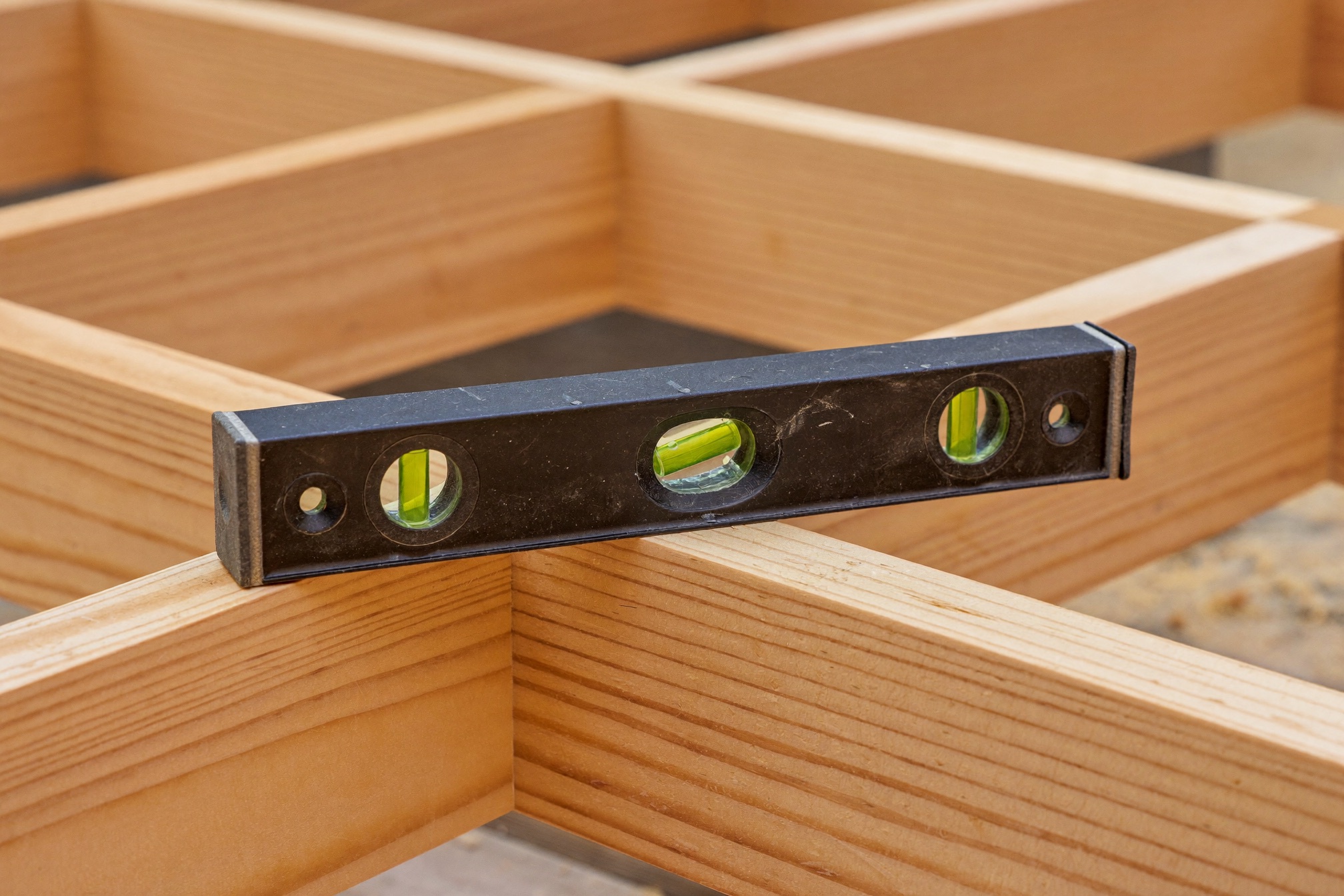 A carpenter's spirit level resting level and true on fresh framing lumber